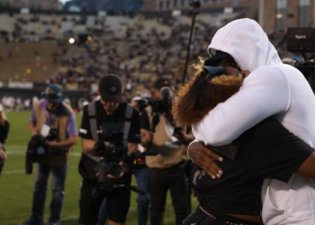 Deion Sanders hugging daughter Shelomi Sanders